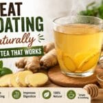 Bloated stomach ginger tea recipe with fresh ginger, lemon, and warm herbal tea in a glass cup